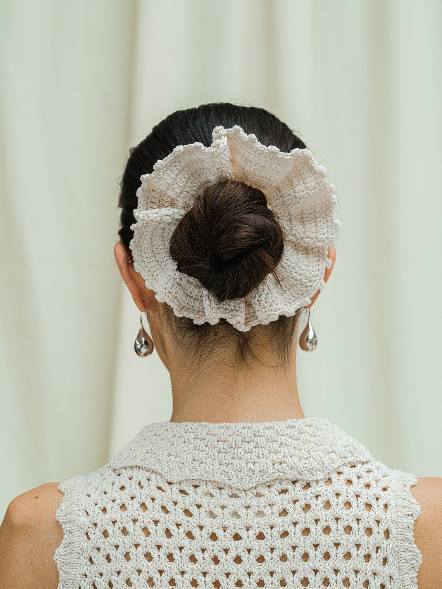 Back view of hand crocheted scrunchie in linen white.