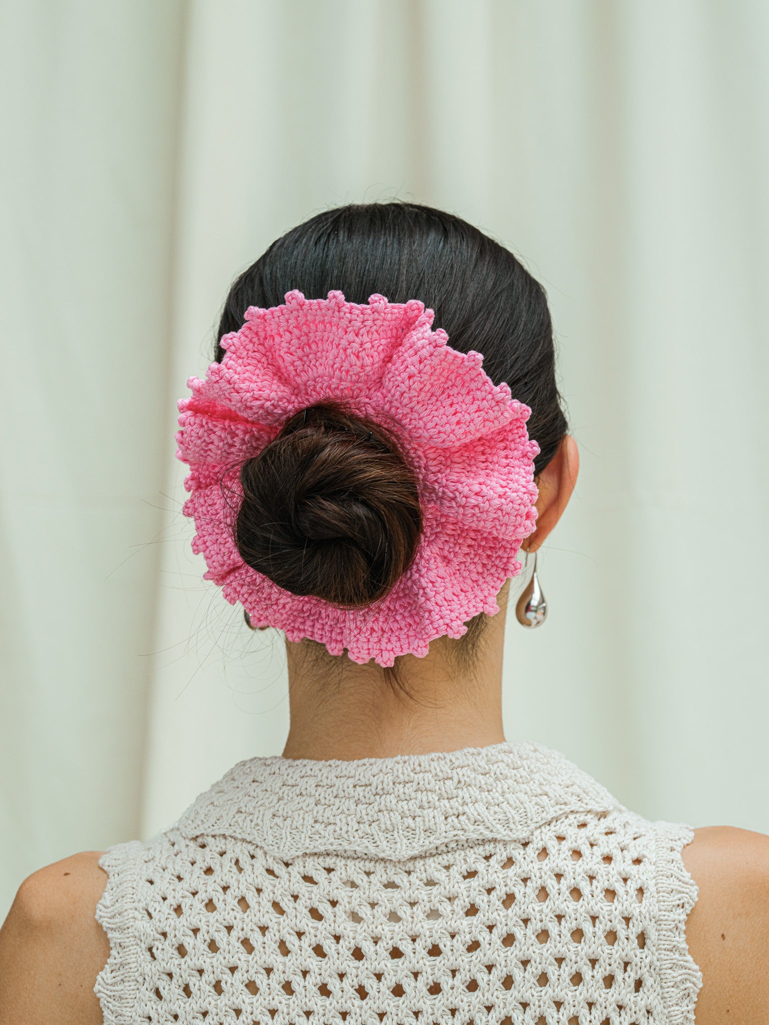 Back view of hand crocheted scrunchie in peony pink.