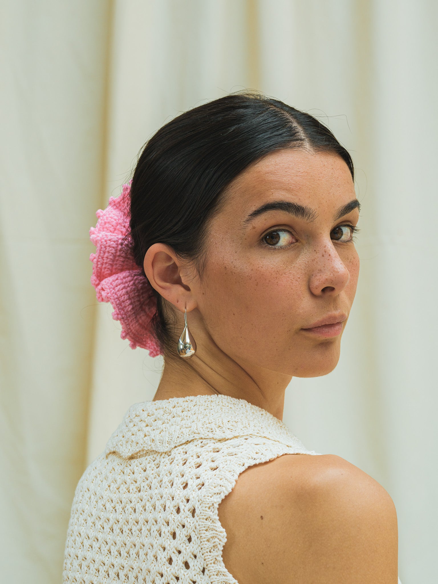 Front view of hand crocheted scrunchie in peony pink.