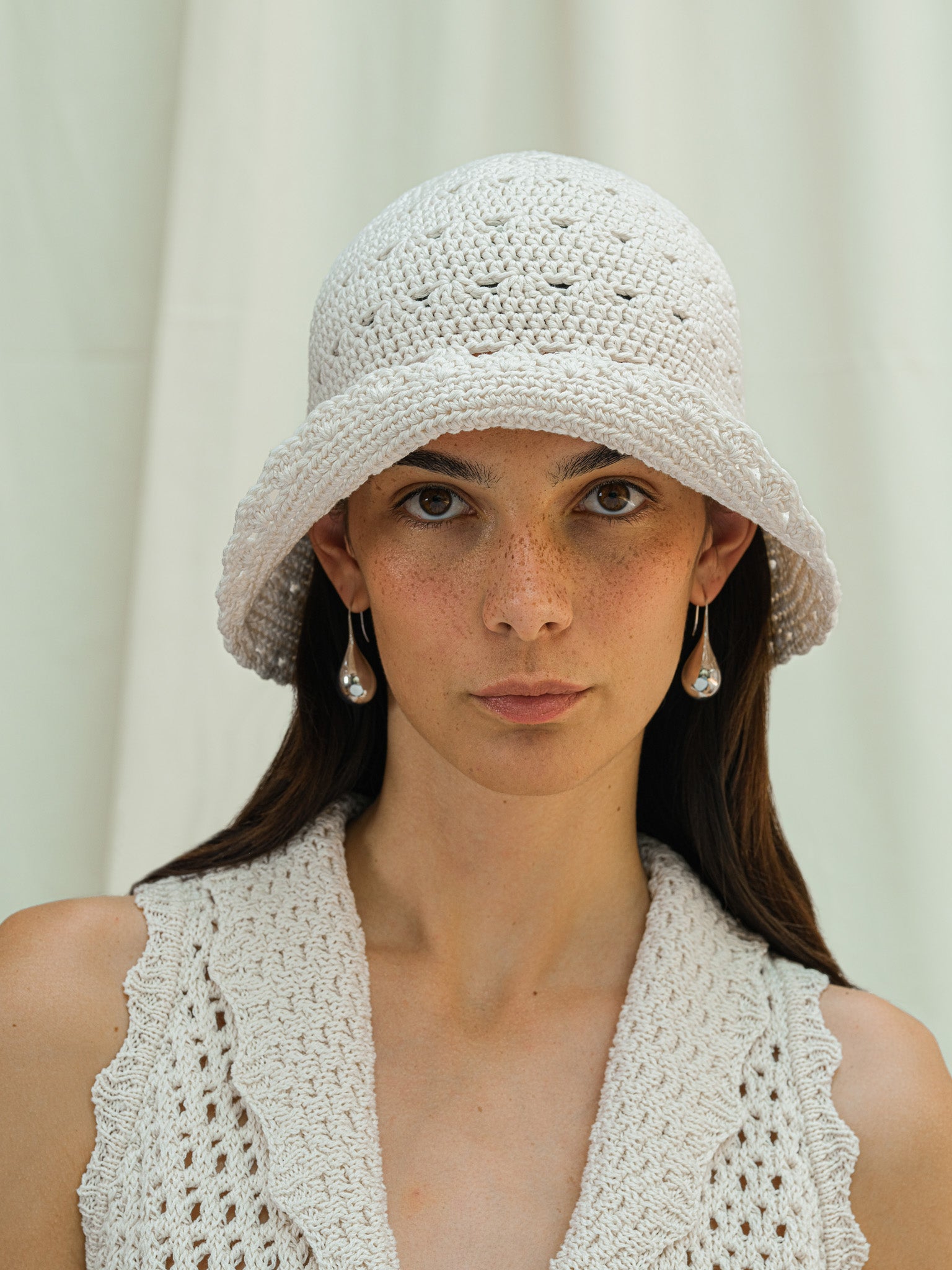 Front view of hand crocheted shell sun hat in linen white